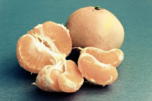 Fresh mandarins to pieces on the table  - vintage retro color tone