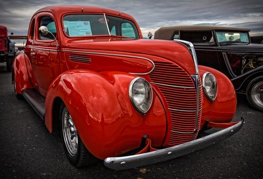 Redding, California, USA- September 28, 2014: A bright red Ford Standard from the late 1930's is proudly on display at a car show at the Redding airport.