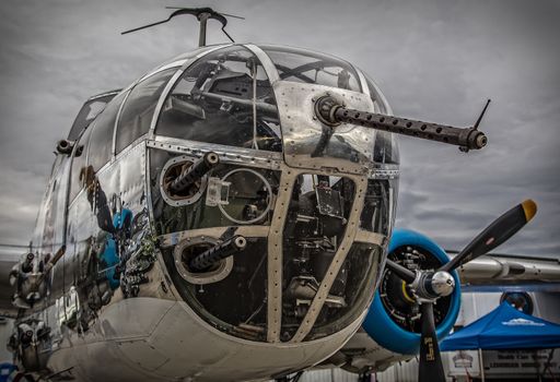 Redding, California, USA- September 28, 2014: A WWII era b-25 Mitchell bomber sits on display at an airshow in northern California and showcases it's 50 calibre machine guns and highly polished skin.