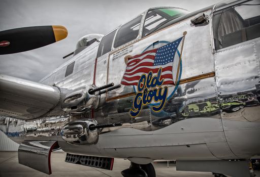 Redding, California, USA- September 28, 2014: A WWII era b-25 Mitchell bomber sits on display at an airshow in northern California and showcases it's 50 calibre machine guns and highly polished skin.