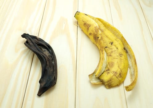 dried banana peels on wood table.