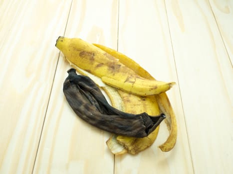 dried banana peels on wood table.