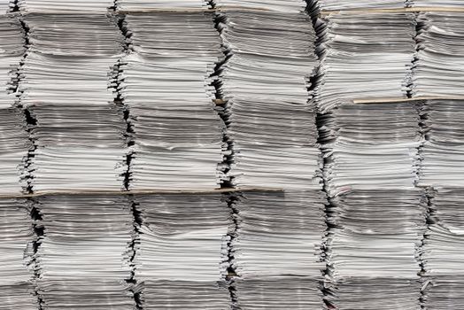 Horizontal shot of many newspaper stacks.  Can be used as a background