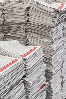 Vertical shot of tall stacks of newspapers