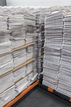 Shot of big stacks of newly printed newspapers