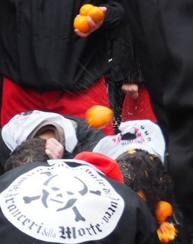 ITALY, Ivrea: People are hit with fruit during the battle of oranges on February 7, 2016, in Ivrea, Italy.An estimated 7,000 people turned out to pelt each other at the historic festival. 70 people were injured by the flying fruit.