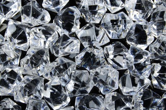 Photo of diamonds on black background surface.
