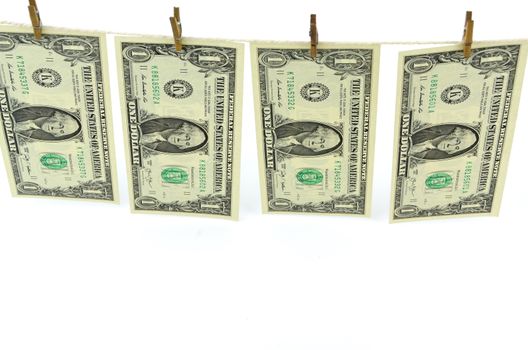 Dirty money hanging from a clothesline isolated on white.

