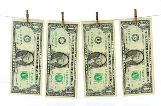 Dirty money hanging from a clothesline isolated on white.
