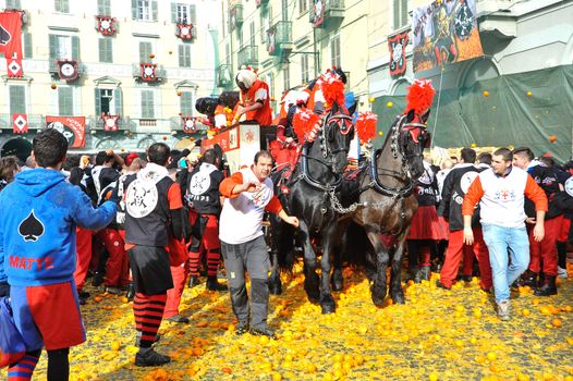 ITALY, Ivrea: Horses and people walk among the destroyed oranges in Ivrea, Italy on February 8, 2016.This unique event sees people re-enact a middle age battle using oranges. Thousands gathered in the town to pelt each other with the fruit, which is imported from Sicily. 