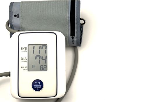 Digital blood pressure gauge on white background.
