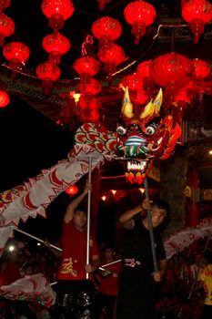 INDONESIA, Kuta: Revelers celebrate the Lunar New Year at a temple in Kuta, Bali, Indonesia as they perform a traditional dance with a dragon on February 8, 2016. Others pray, and light candles and incense as they welcome the Year of the Monkey.