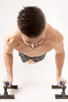 Strong model man doing push up exercises