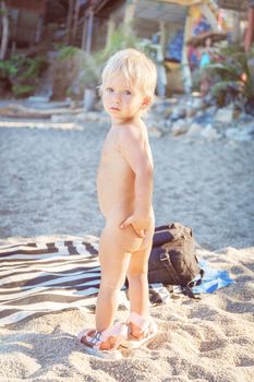 Little baby with a naked torso on the beach