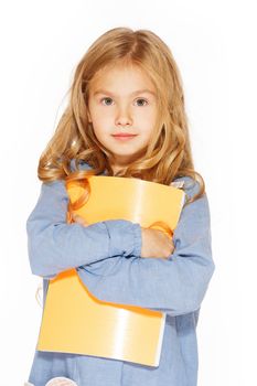 Beautiful little girl in blue dress with copybook. Isolated on white.