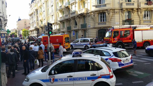 Nice, France - October 16 2015: French Police officers and Firefighters at Building Fire. Emergency Vehicles in the Streets of Nice (French Riviera) in France