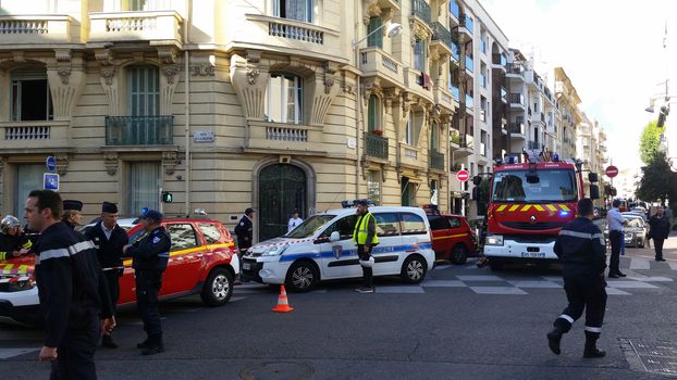 Nice, France - October 16 2015: French Police officers and Firefighters at Building Fire. Emergency Vehicles in the Streets of Nice (French Riviera) in France