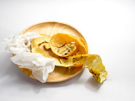 orange's peel and seeds with tissue paper on white background