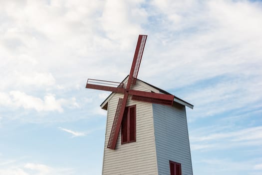 Windmill with blue sky in background.