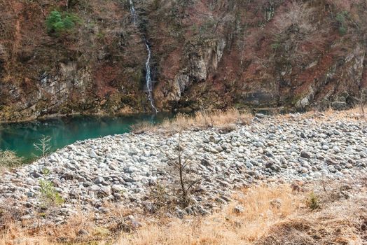 Stone ground beside the river.With little waterfall.