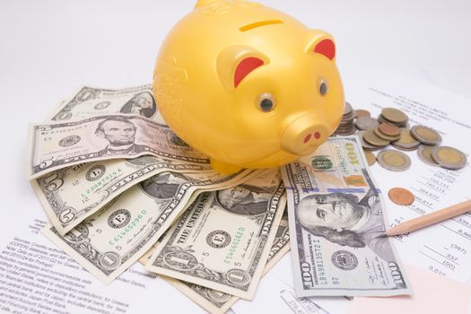 A piggy bank with money dollars and calculator  on financial report, savings