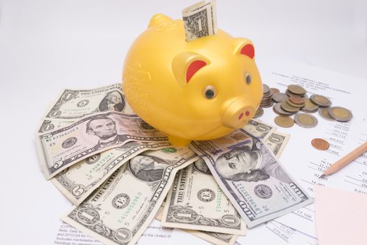 A piggy bank with money dollars and calculator  on financial report, savings