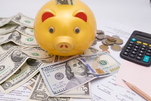 A piggy bank with money dollars and calculator  on financial report, savings