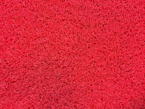 Texture of red fiber carpet.