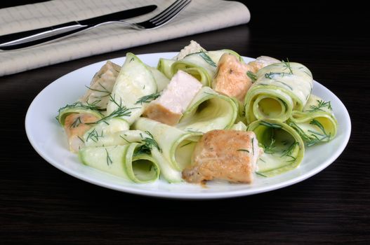 Zucchini salad with slices of chicken breast in milk sauce and dill