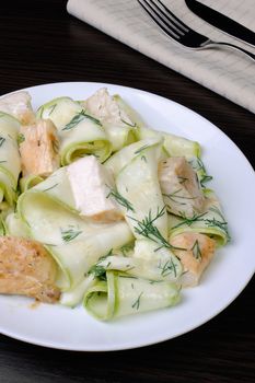 Zucchini salad with slices of chicken breast in milk sauce and dill