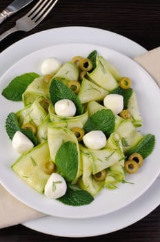 Zucchini salad with mozzarella, olives, dill and mint