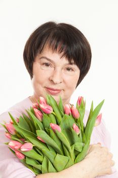 the beautiful mature woman with a bouquet of tulips