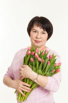 the beautiful mature woman with a bouquet of tulips