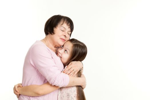 the beautiful mature woman embraces the granddaughter