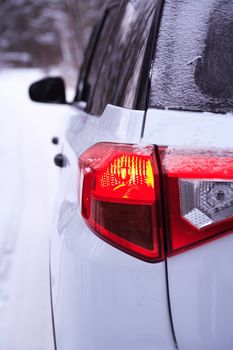 Closeup of new modern black and white car with lighting parking lights