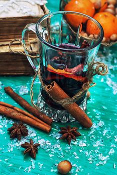 glass of mulled wine,old books and basket of ripe tangerines