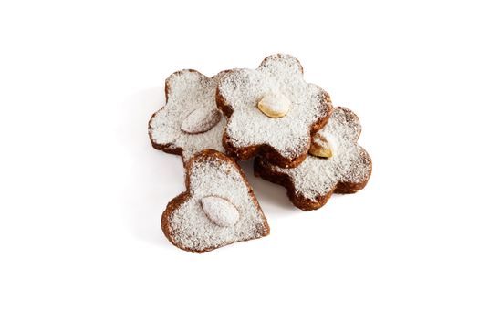 Chocolate cakes with nuts and powdered sugar on a white background