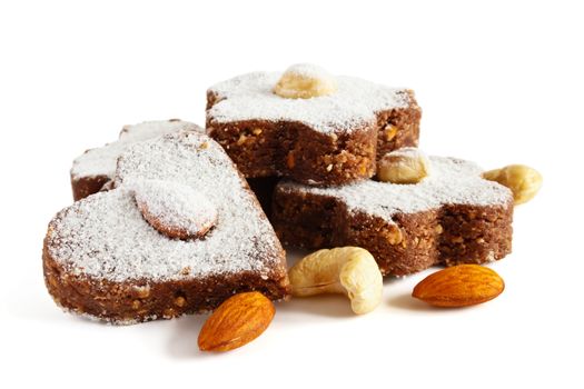 Chocolate cakes with nuts and powdered sugar on a white background