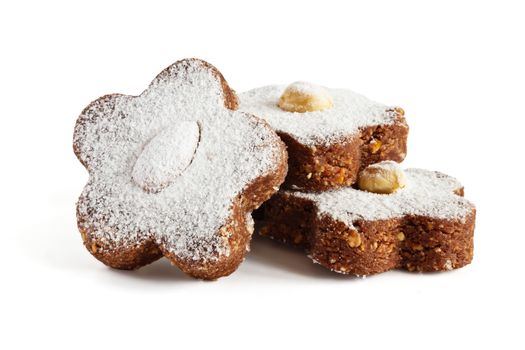 Chocolate cakes with nuts and powdered sugar on a white background