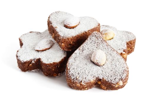 Chocolate cakes with nuts and powdered sugar on a white background