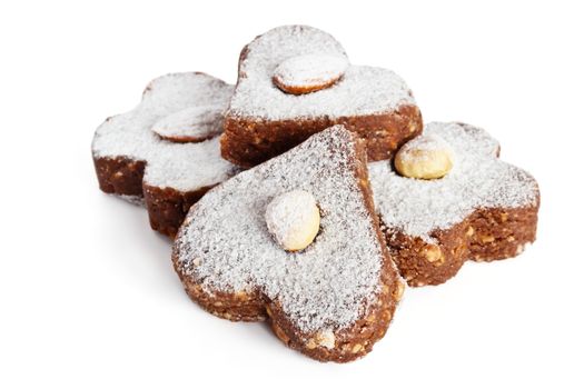 Chocolate cakes with nuts and powdered sugar on a white background