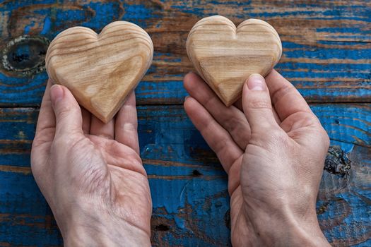 two symbolic wooden heart in your hands