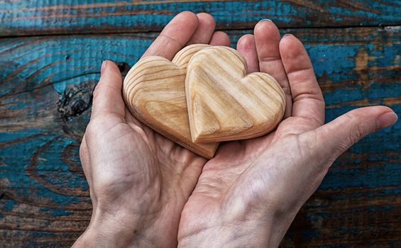 two symbolic wooden heart in your hands