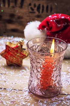 festive decoration with Christmas hat and a burning candle