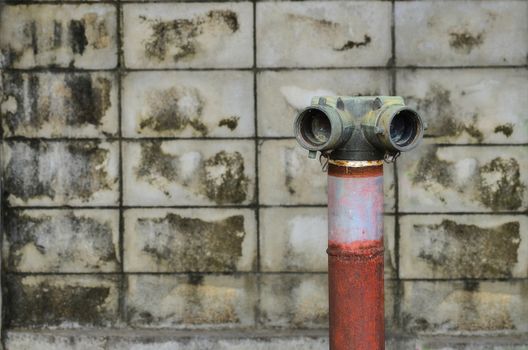 red fire hydrant near a cement wall