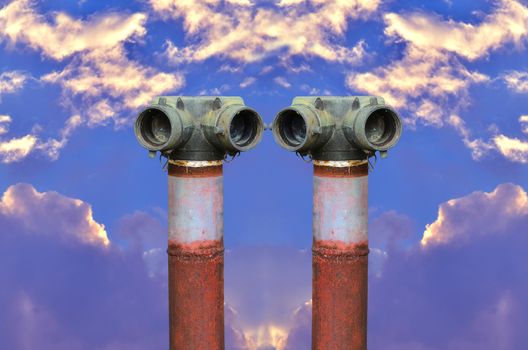 Two red fire hydrant on blue sky background