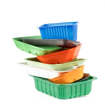 Stack of Various Colored Empty Recycled Trays isolated on White background