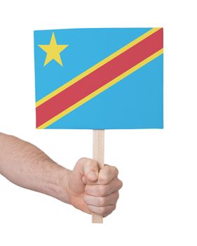 Hand holding small card, isolated on white - Flag of Congo