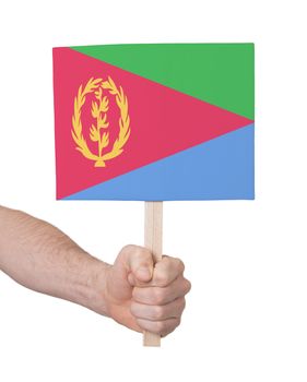 Hand holding small card, isolated on white - Flag of Eritrea