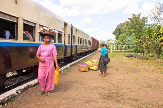 BAGO, MYANMAR - November 16, 2015: Hawkers selling goodies. Trains in lower Myanmar are little communities of their own with hawkers selling everything imaginable.
